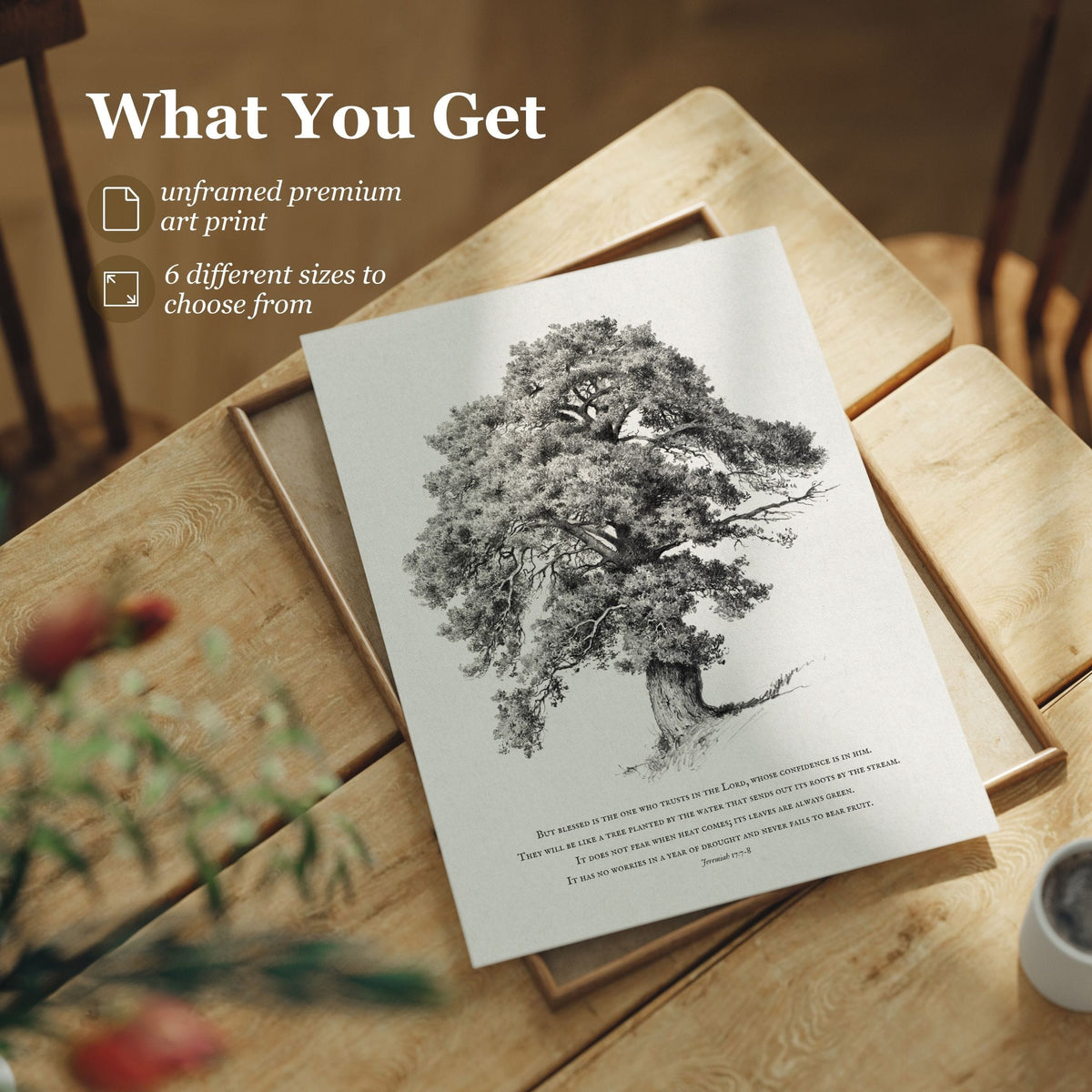 A framed art print featuring a detailed black and white tree illustration with a quote below, styled on a wooden tray over a wooden table. Text on the top left reads 'What You Get' with bullet points for 'unframed premium art print' and '6 different sizes to choose from'.