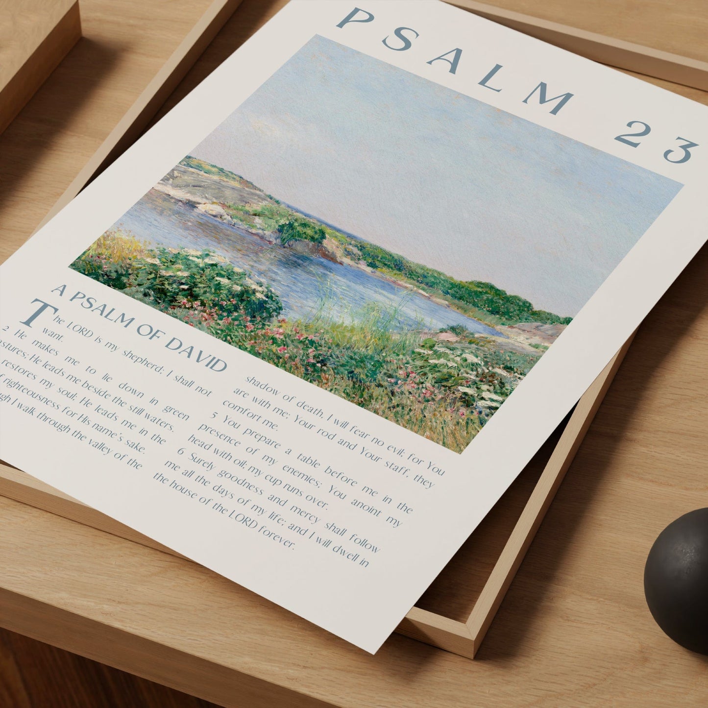 Psalm 23 art print with landscape illustration and text on a wooden surface