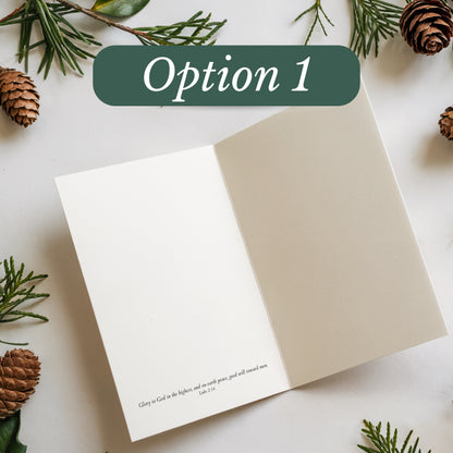 Open notebook with a quote on a white surface with greenery and pine cones.