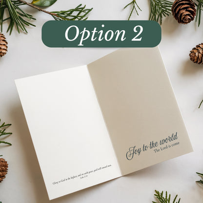 Open card with 'Joy to the world' text on a white background with pine branches and cones.