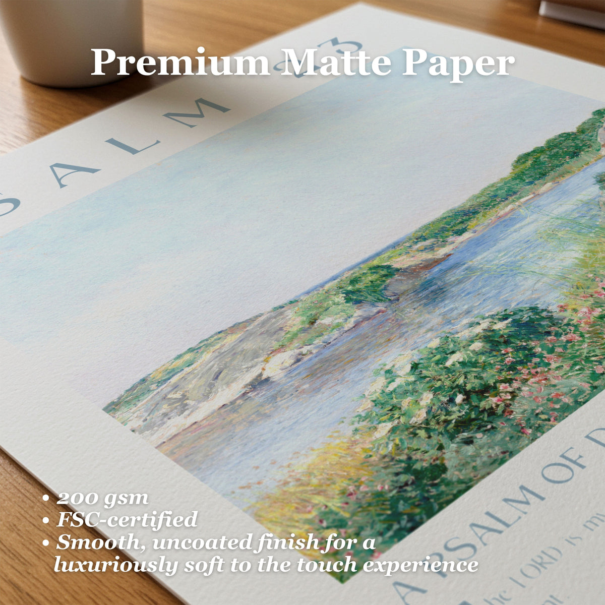 A close-up of a premium matte paper sheet featuring a painted landscape scene with water, greenery, and flowers. White text overlays read 'Premium Matte Paper' and include product features like '200 gsm', 'FSC-certified', and 'Smooth, uncoated finish for a luxuriously soft to the touch experience'.