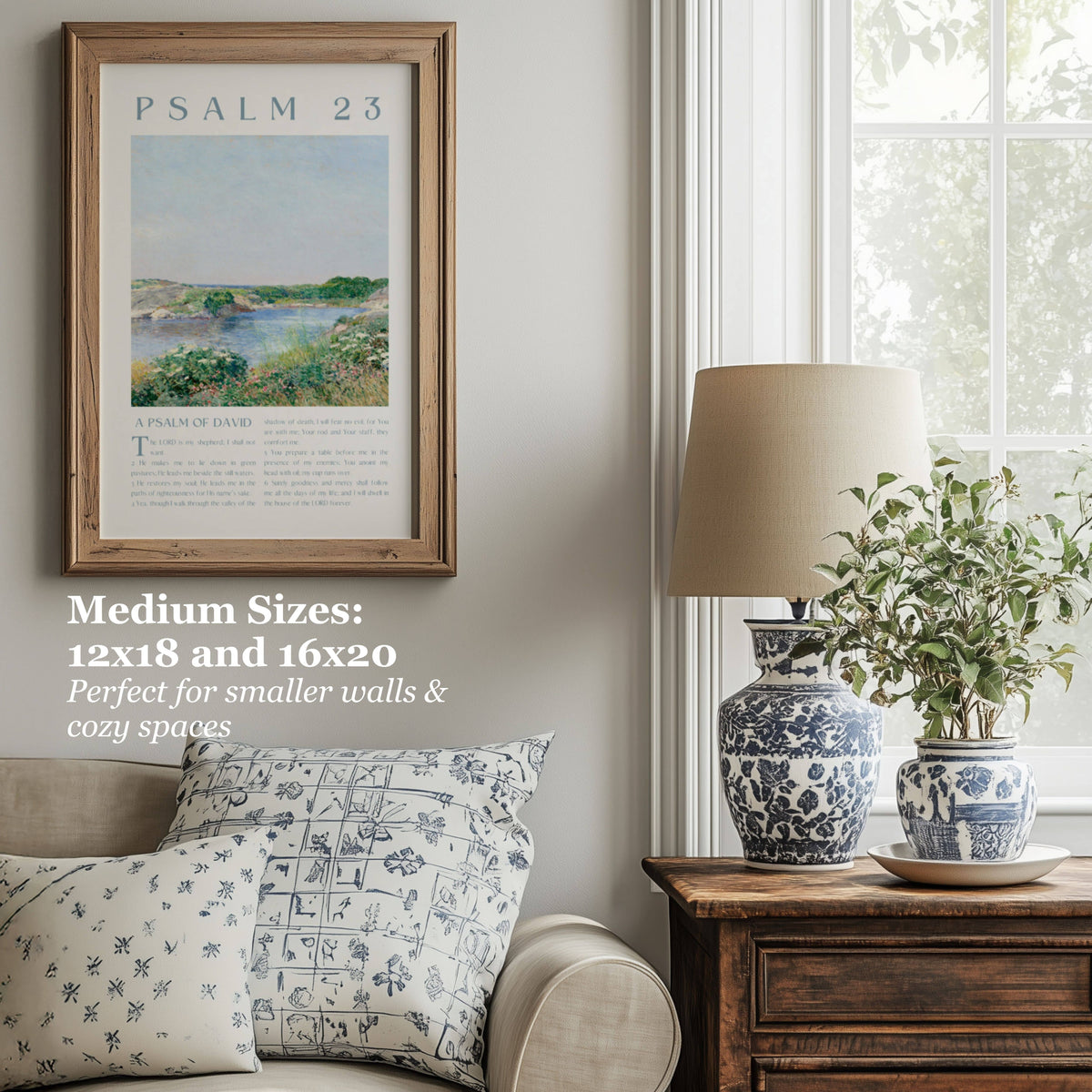 Framed wall art featuring Psalm 23 in a rustic wood frame, styled in a cozy living room setting next to a window with a blue-and-white patterned vase and a lamp.