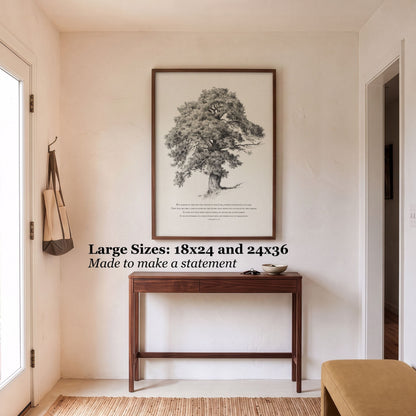 A framed botanical art print of a tree hangs on a beige wall above a dark wood console table in a bright entryway. Text on the image reads: 'Large Sizes: 18x24 and 24x36 Made to make a statement'.