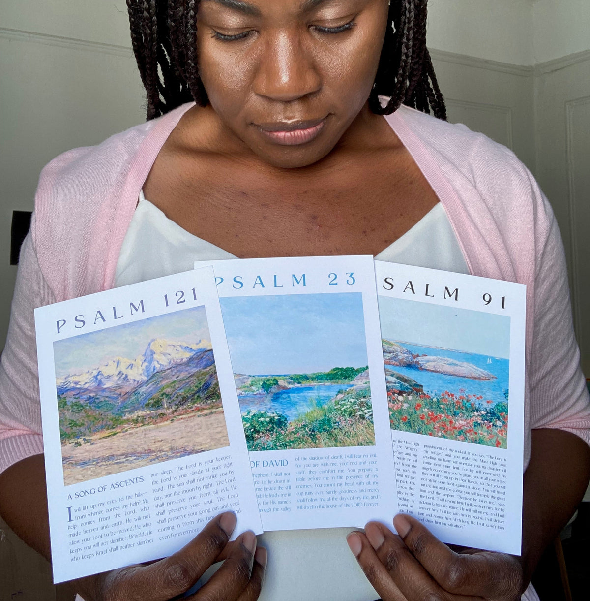 image of founder holding small poster prints of palm 23, 91, 121