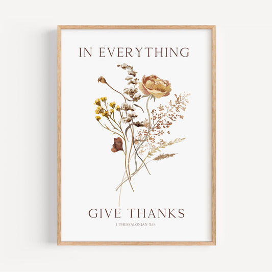 Framed artwork with floral design and text 'In everything give thanks' on a white background