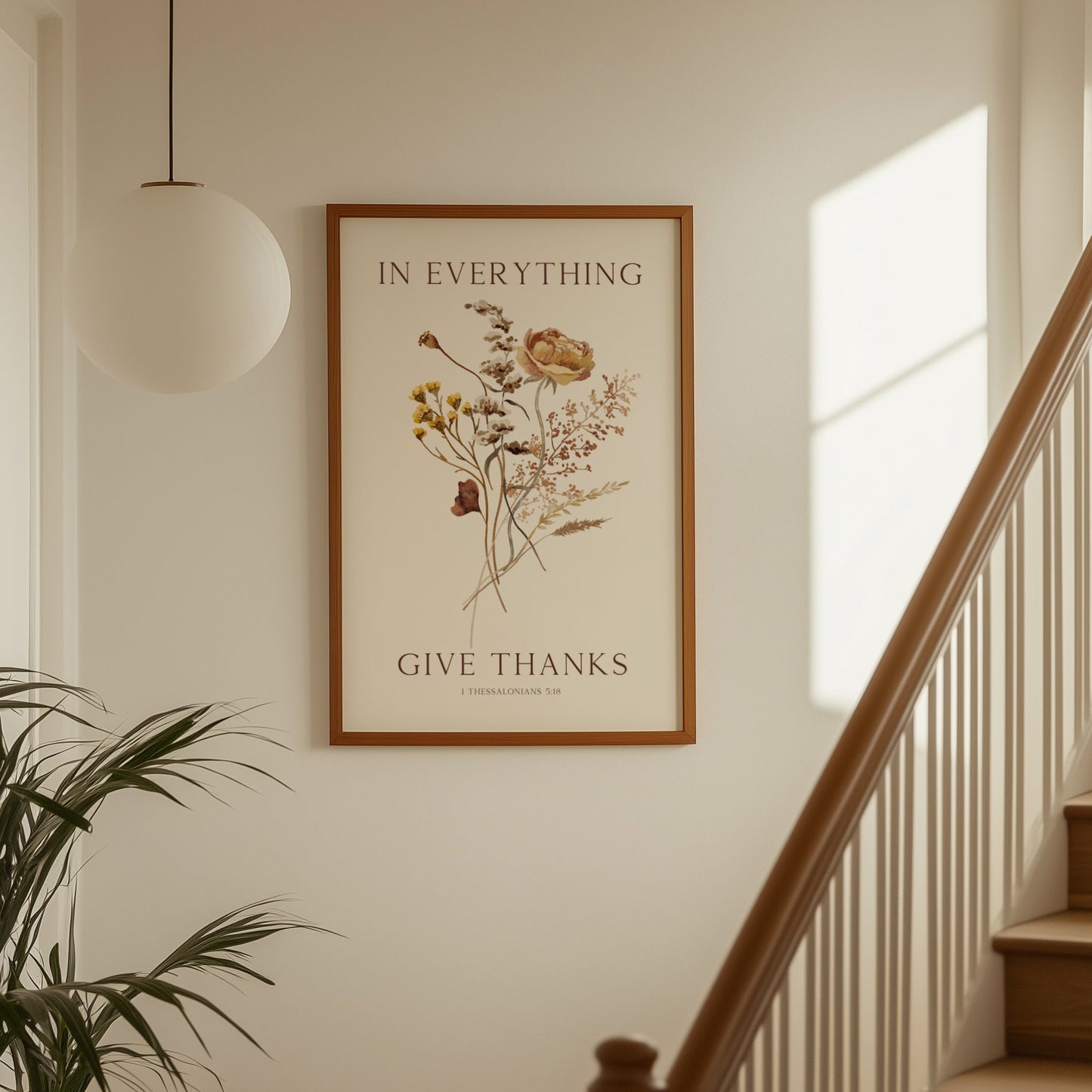 Framed artwork with floral design and text on a wall above a staircase