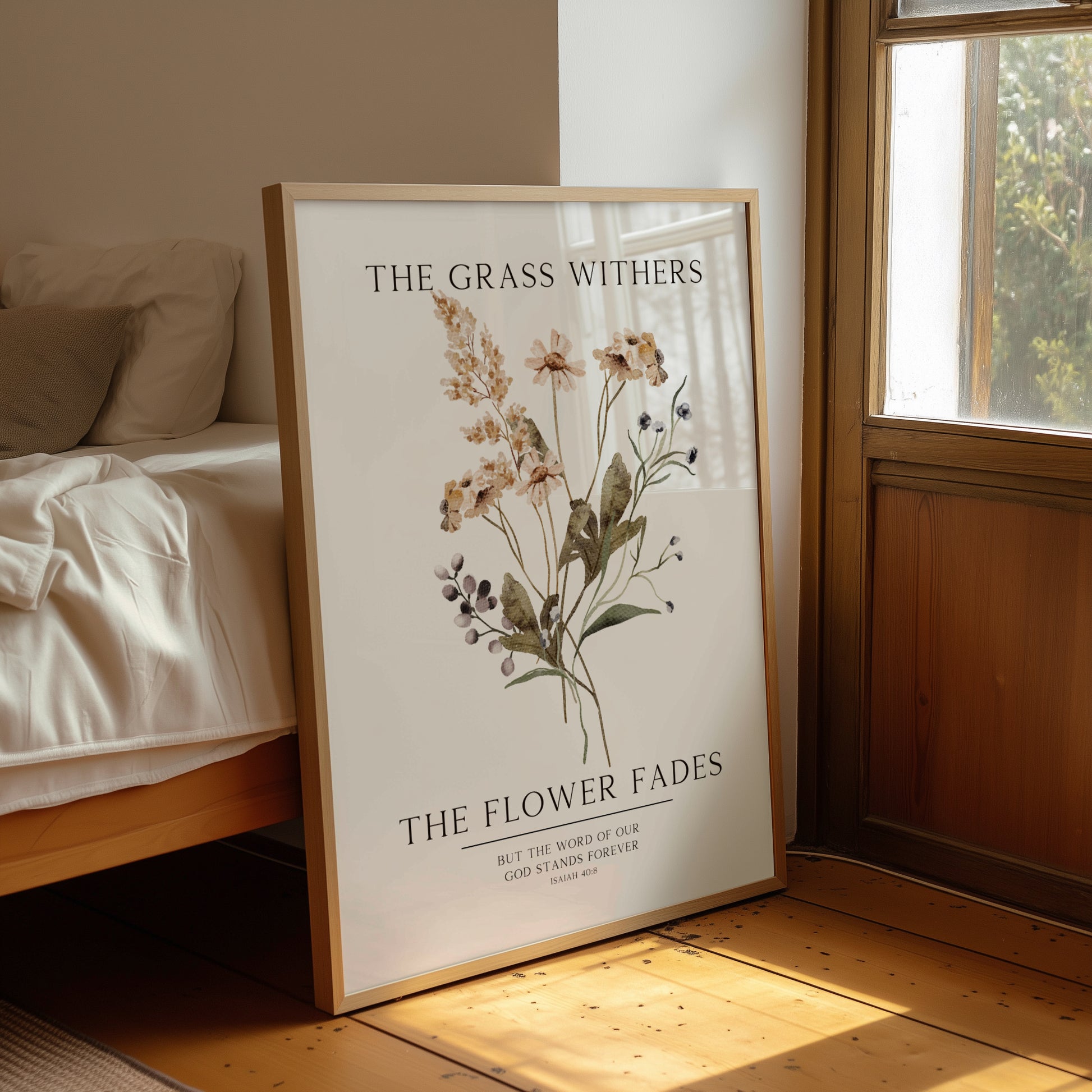 Framed botanical poster with floral design and text in a room with a bed and window.