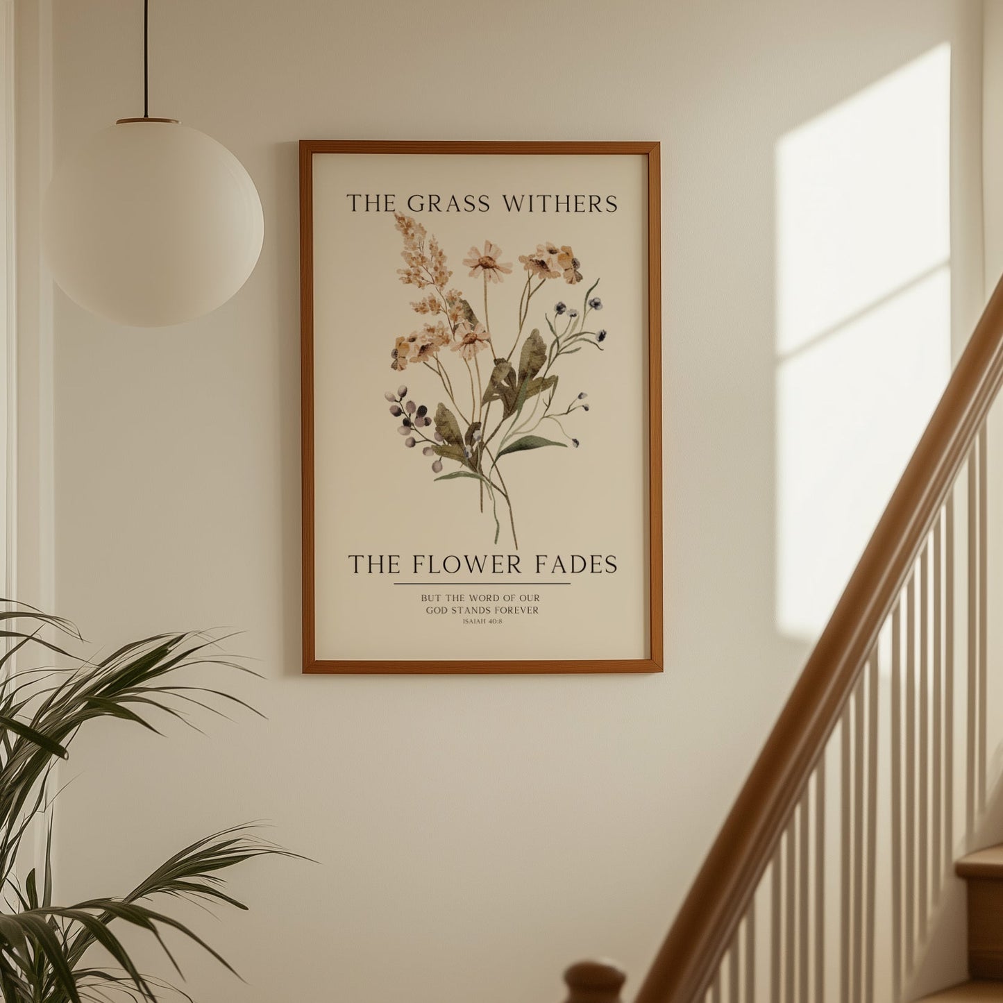 Framed botanical print on a wall above a staircase with a plant to the left.
