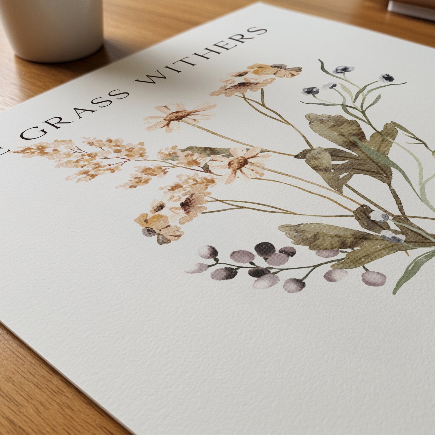 Floral design on a white surface with 'Grass Withers' text.