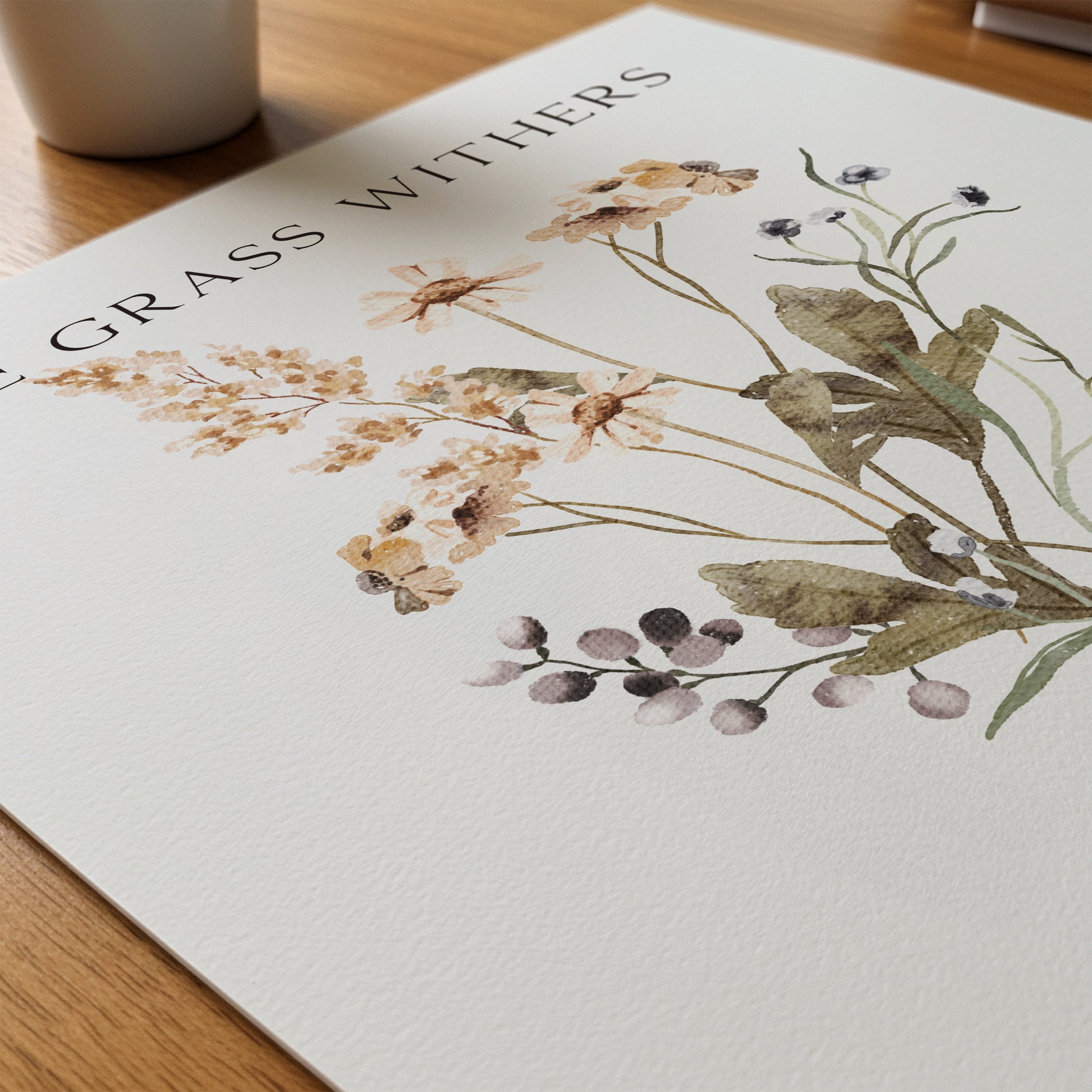 Floral design on a white surface with 'Grass Withers' text.