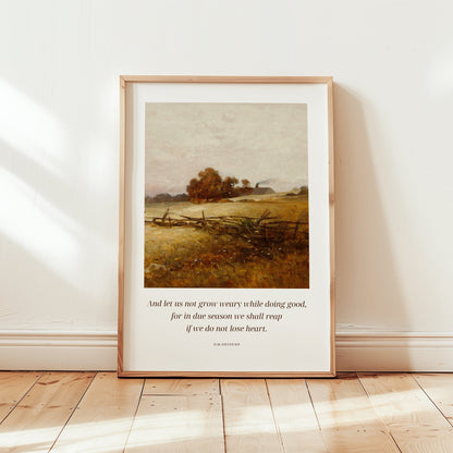 Framed artwork of a landscape with a quote on a white wall.