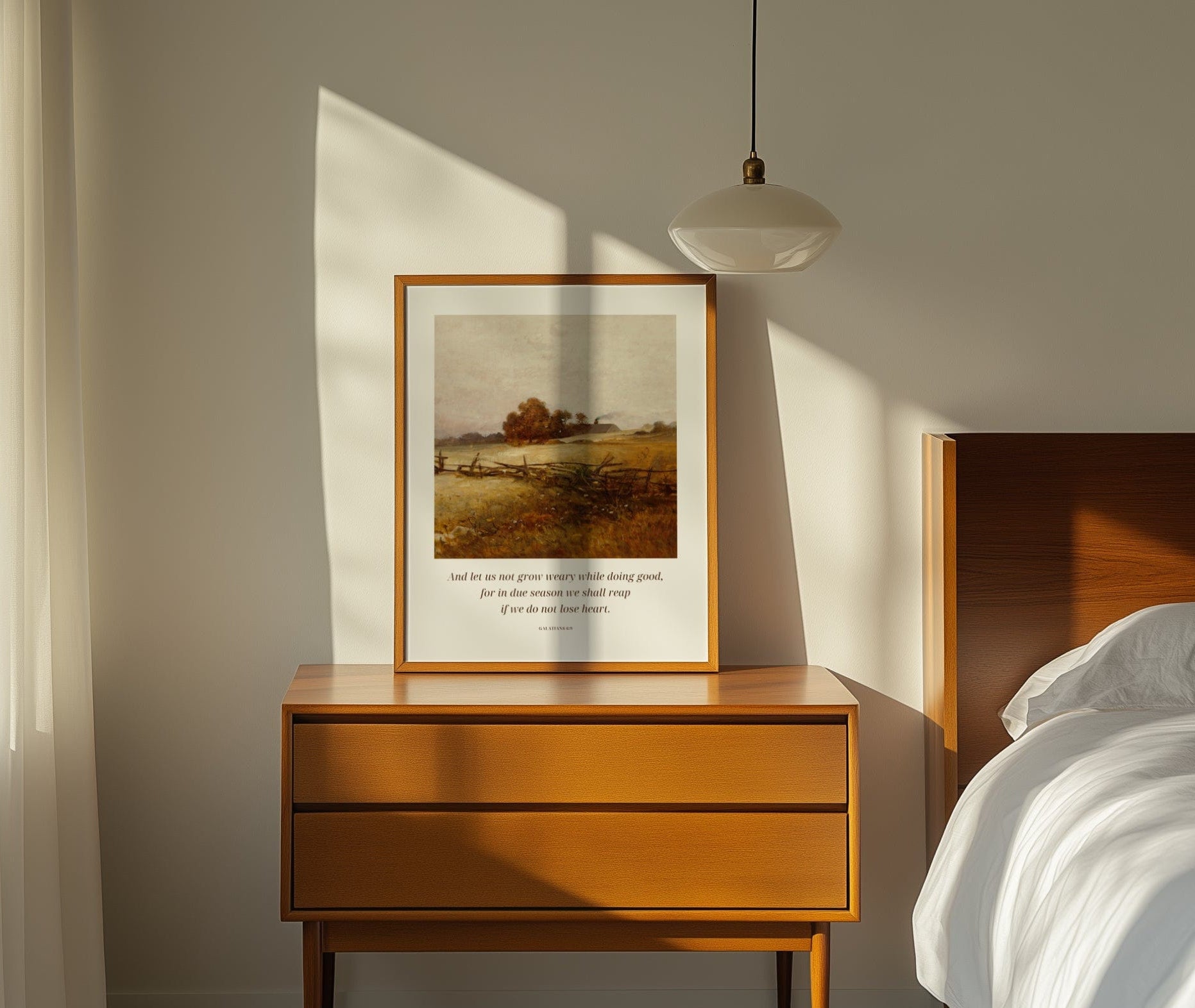 Wooden nightstand with framed artwork in a bedroom setting