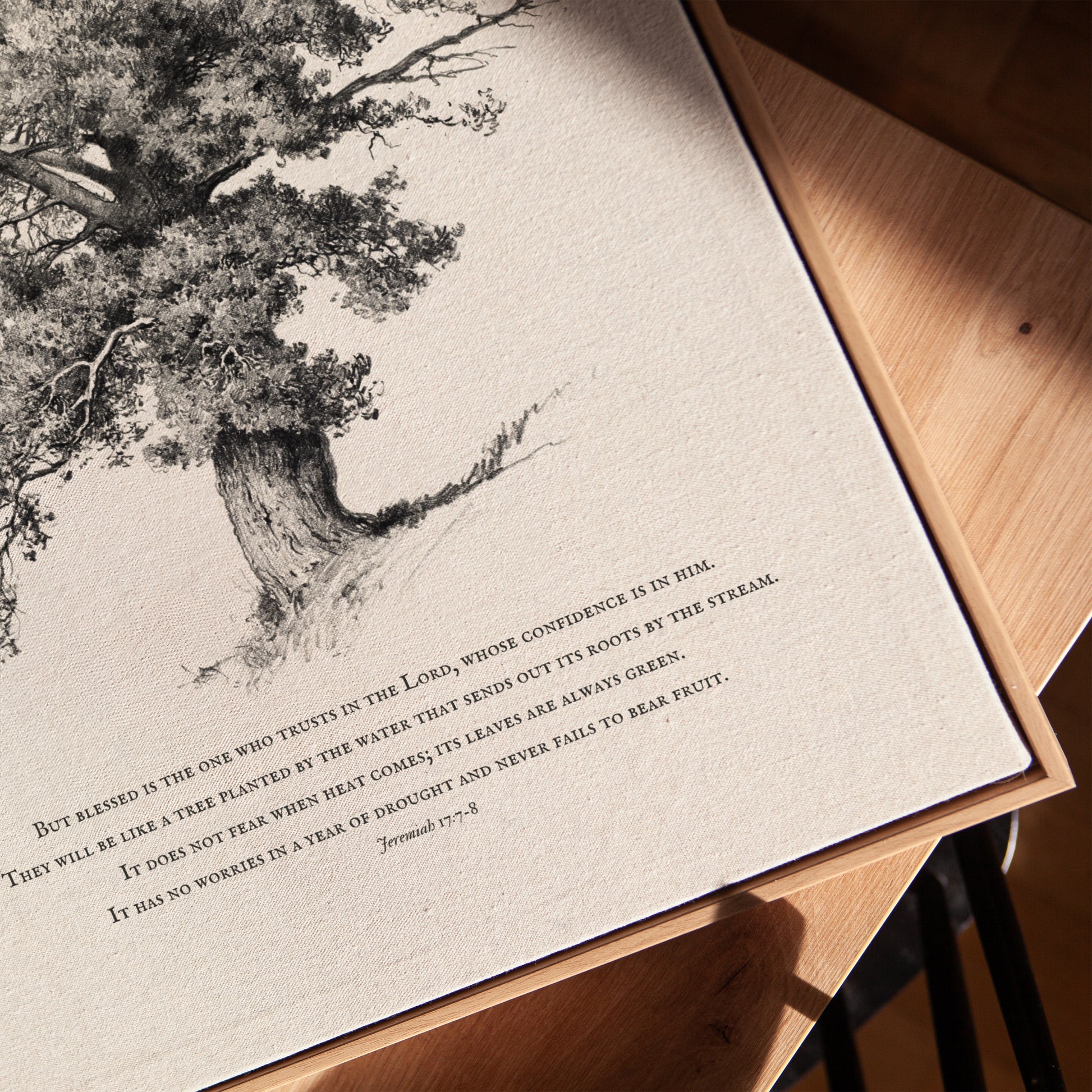 Print with a tree illustration and text on a wooden surface