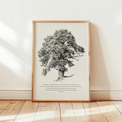 Framed black and white tree print on a wall with wooden floor