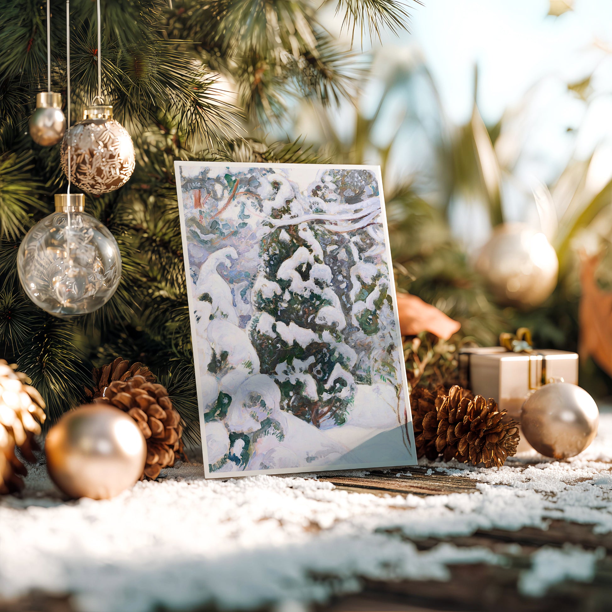 Laptop on a snowy surface with Christmas decorations