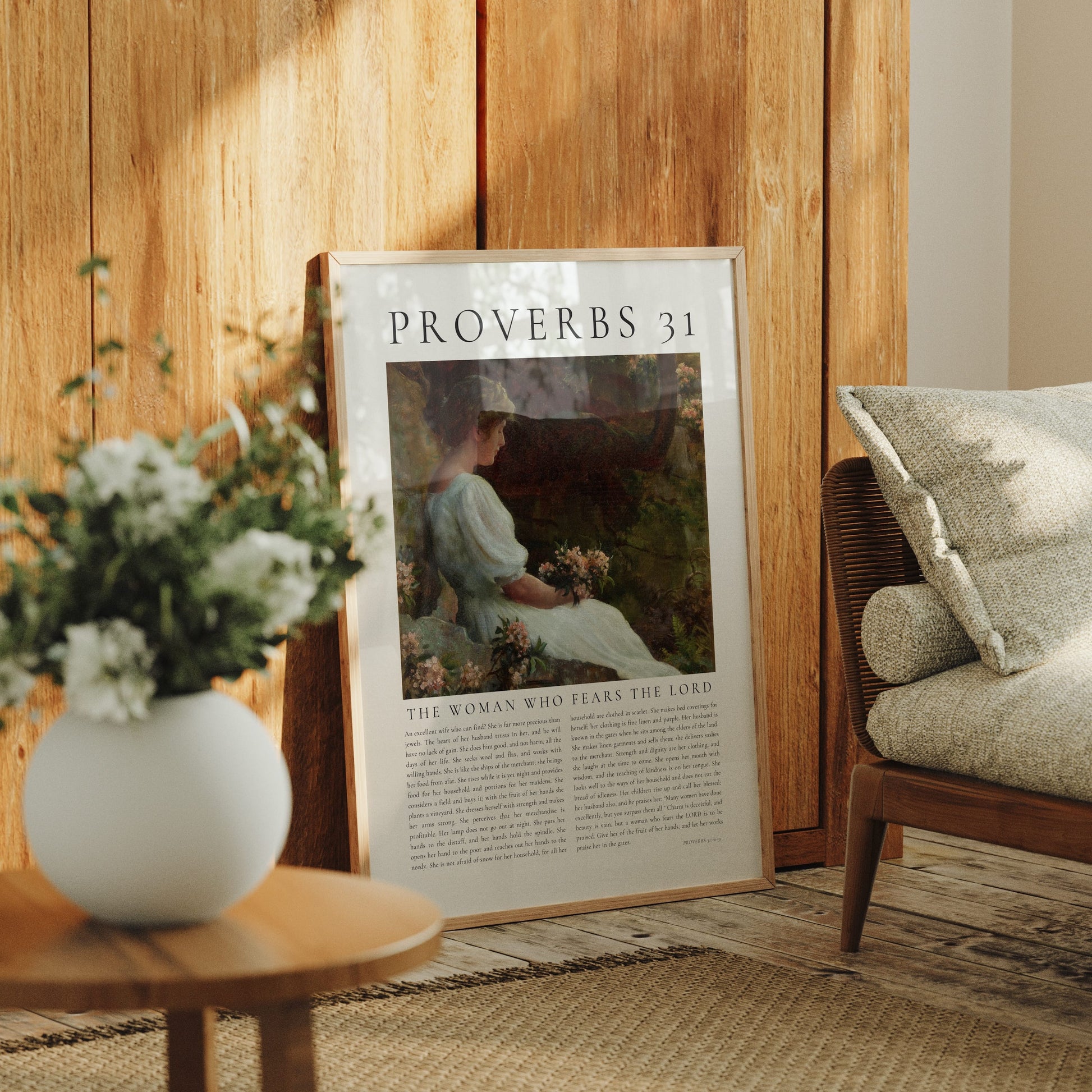 Poster of Proverbs 31 in a home setting with a vase of flowers and a chair.