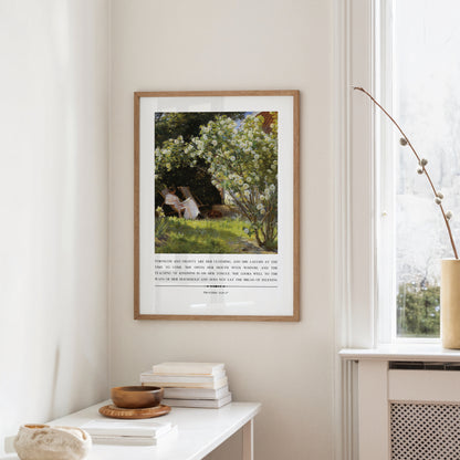 Framed artwork on a wall with a window and books in the foreground