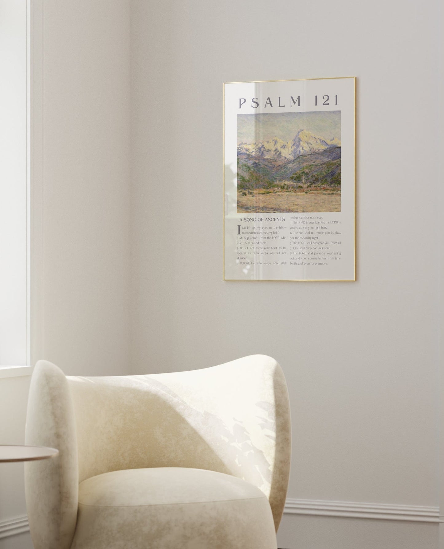 Modern living room with a white armchair, side table, and framed artwork on the wall.