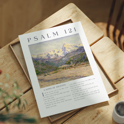 Sheet of paper with 'Psalm 121' text and illustration on a wooden table with a cup and plant.
