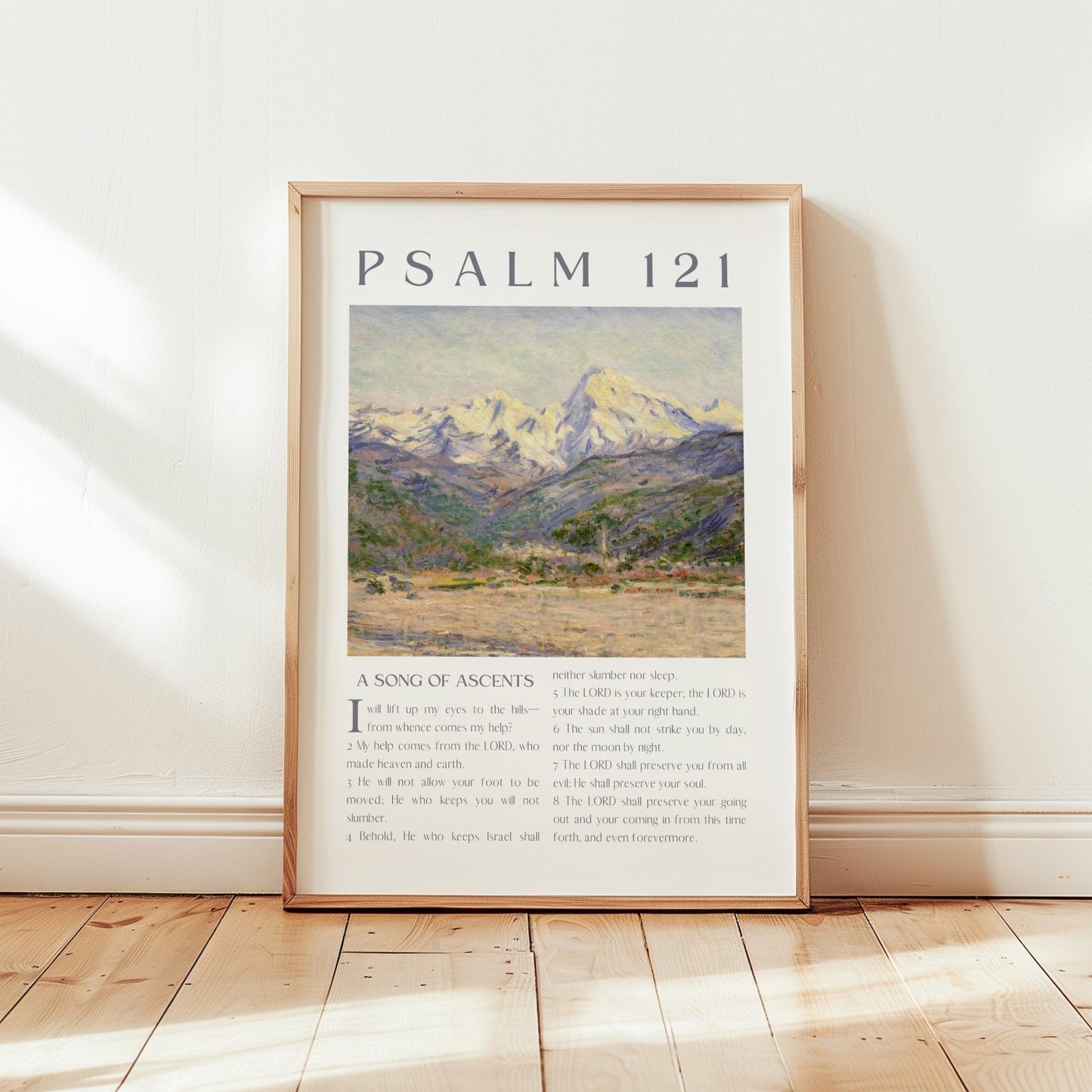 Framed artwork with mountain landscape and text on a wall.