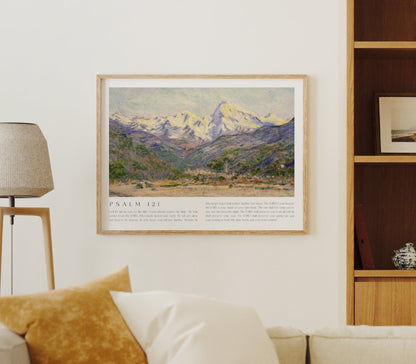 Living room with beige sofa, framed mountain landscape art, and wooden shelf.