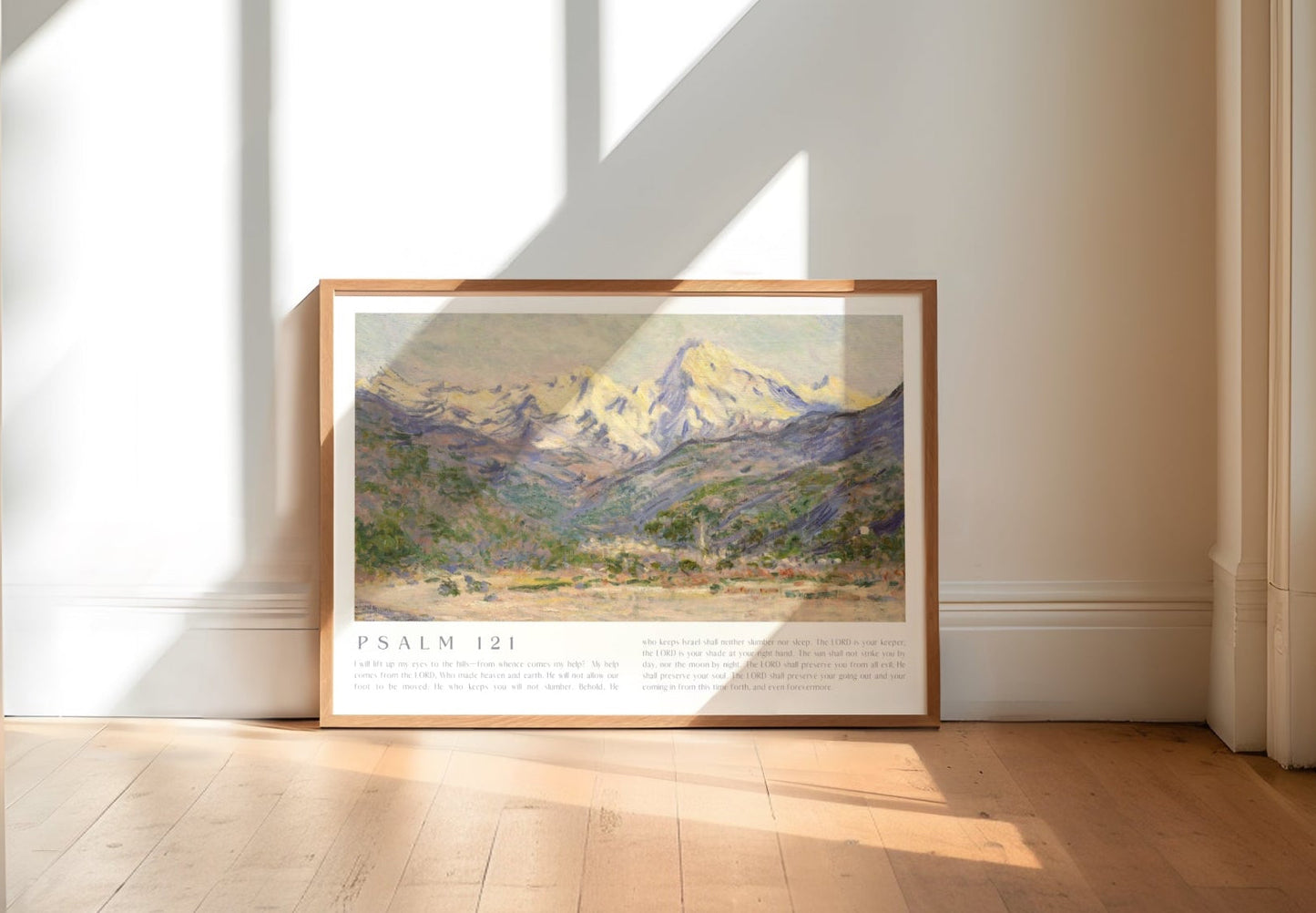 Framed landscape print on a wall in a bright room with sunlight streaming through windows.