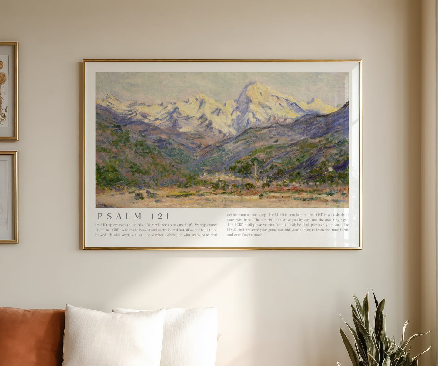 Living room with a framed landscape print on the wall, white sofa, and plant.