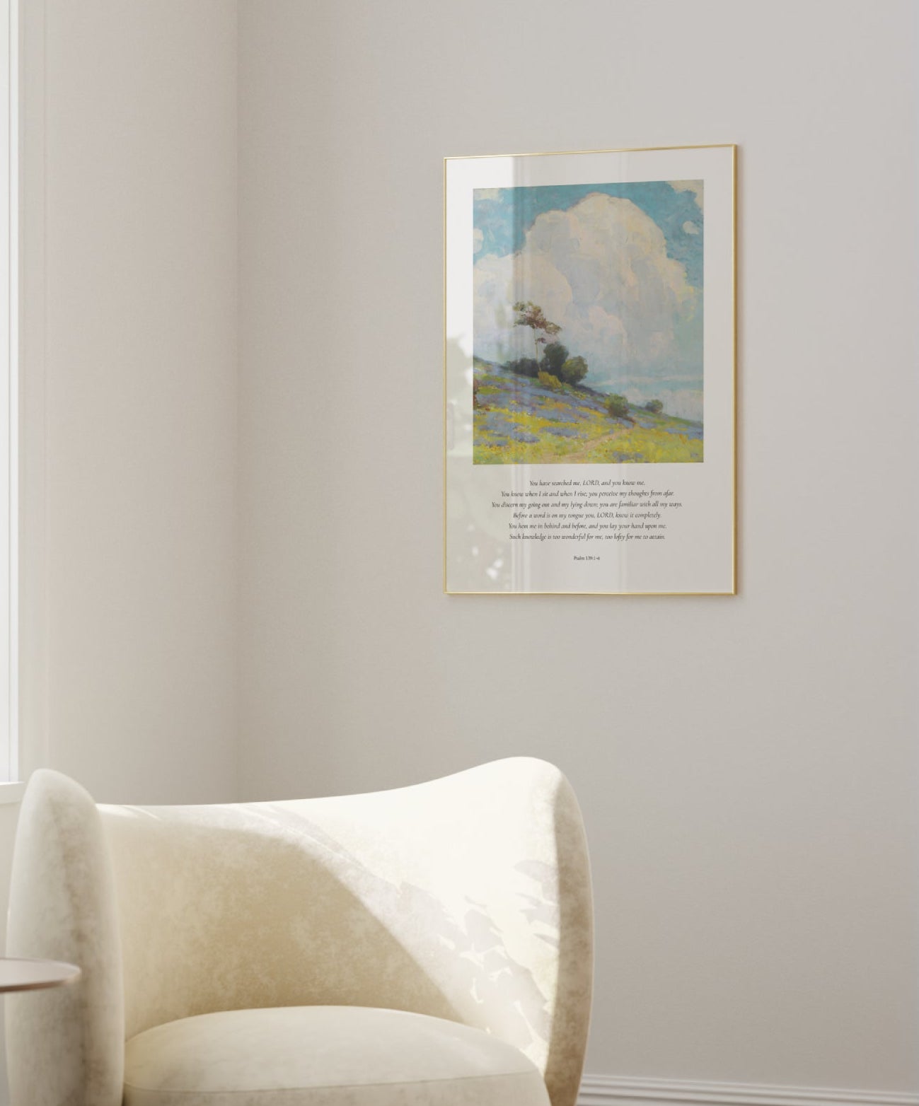 White armchair in a room with a painting on the wall