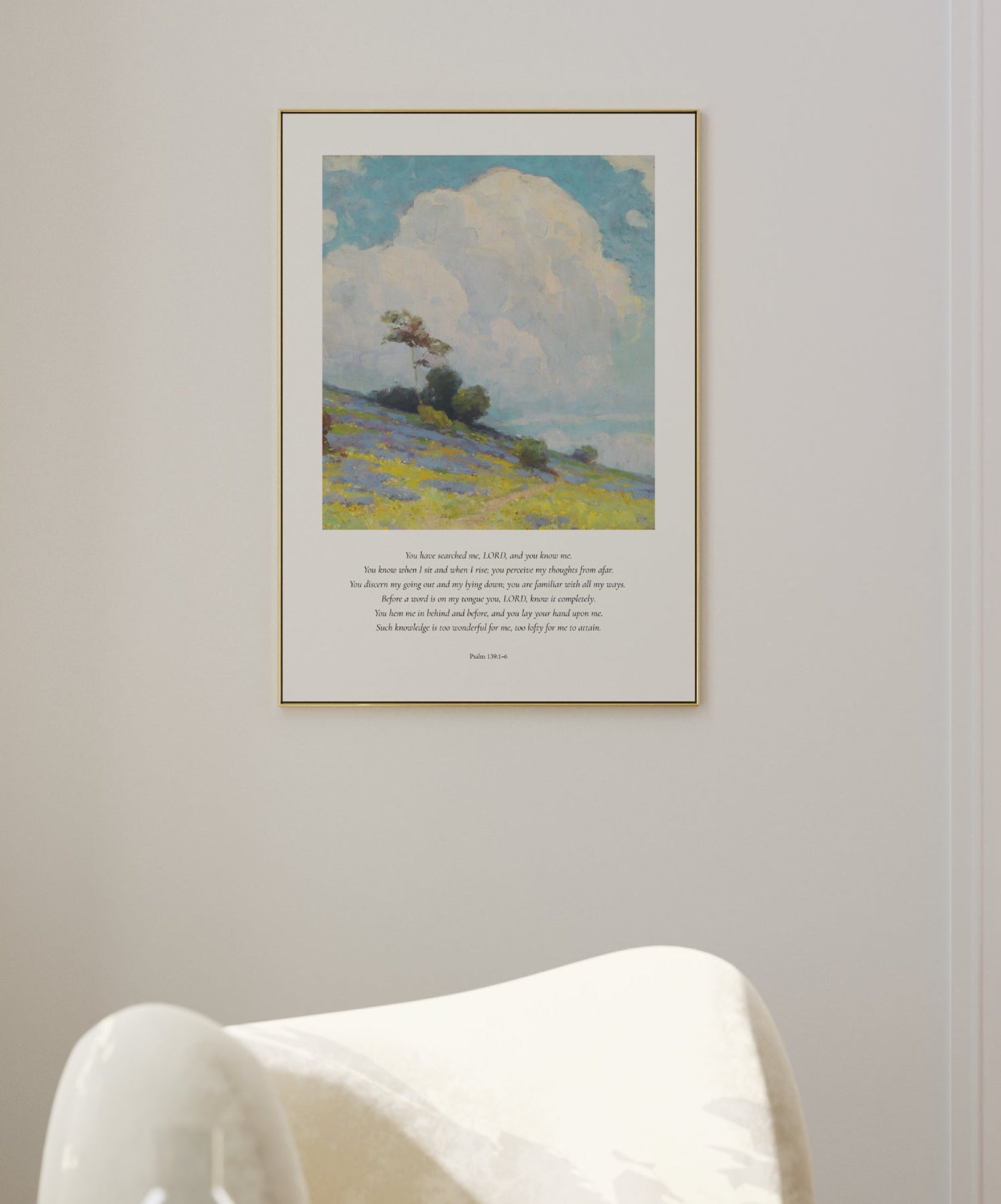 Framed artwork of a landscape with a chair and table in a room.