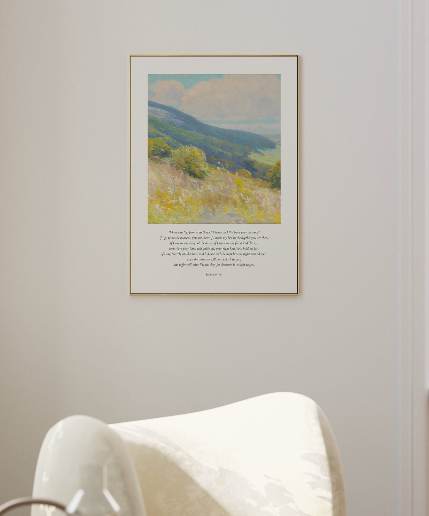Framed artwork of a landscape with a chair and table in a room.