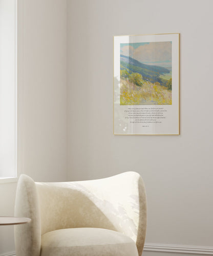 White armchair in a room with a window and a painting on the wall.