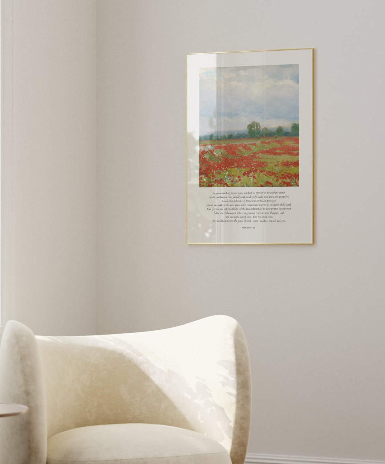 Modern living room with a white armchair, side table, and framed artwork on the wall.