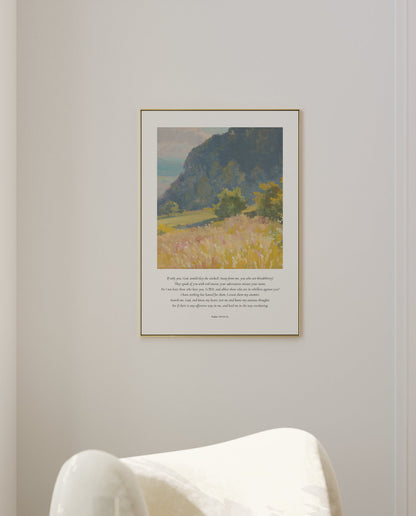 Framed landscape print on a wall above a white chair