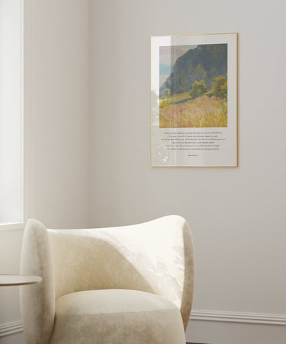 Modern living room with a white armchair, side table, and framed artwork on the wall.