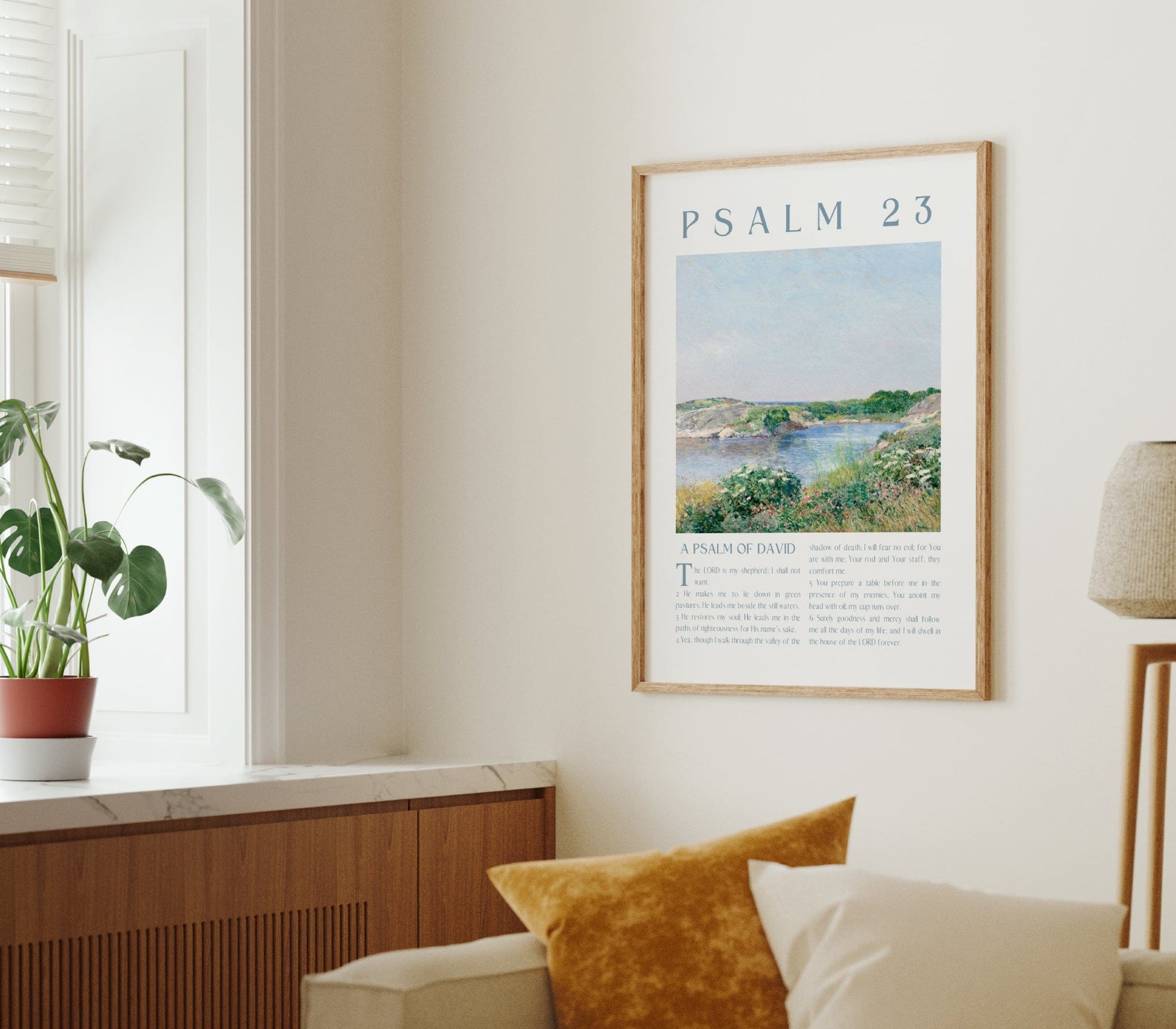 Living room with a framed poster of Psalm 23, a plant on a windowsill, and a lamp.