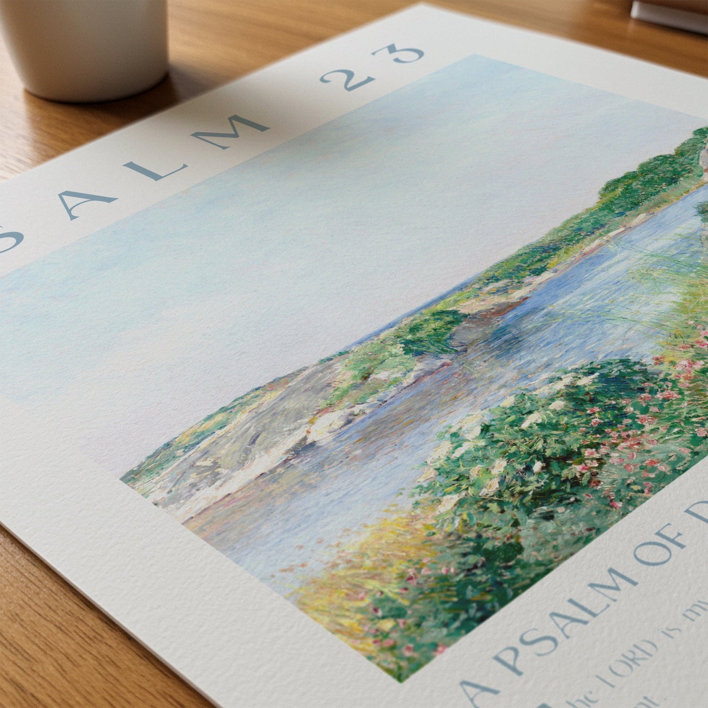 Artistic depiction of a landscape with a river and greenery on a printed page.