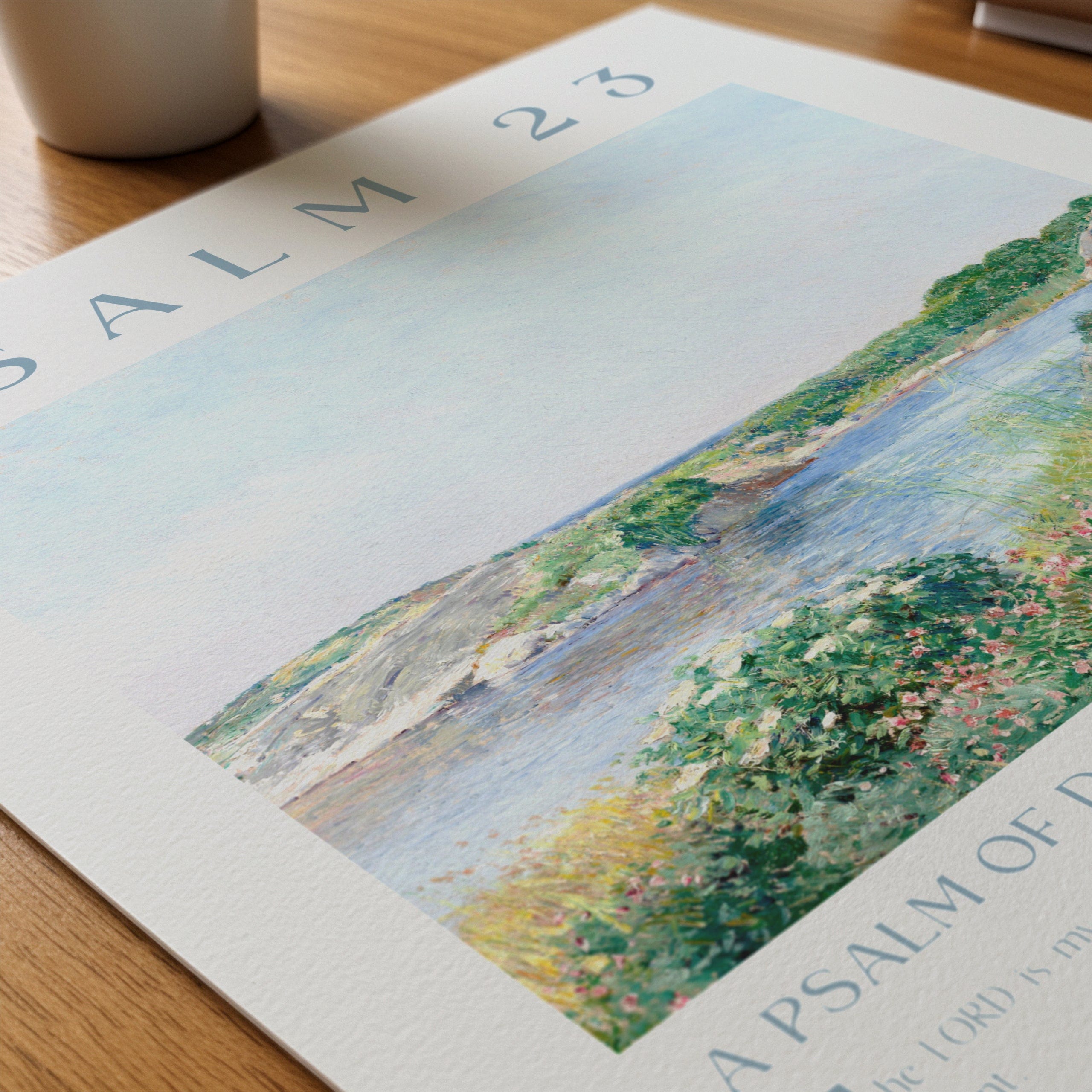 Artistic depiction of a landscape with a river and greenery on a printed page.