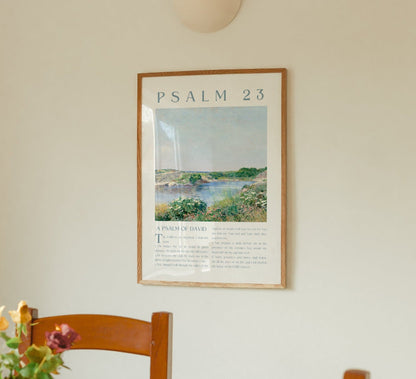 Framed artwork with 'Psalm 23' on a wall above a wooden chair with flowers in the kitchen.