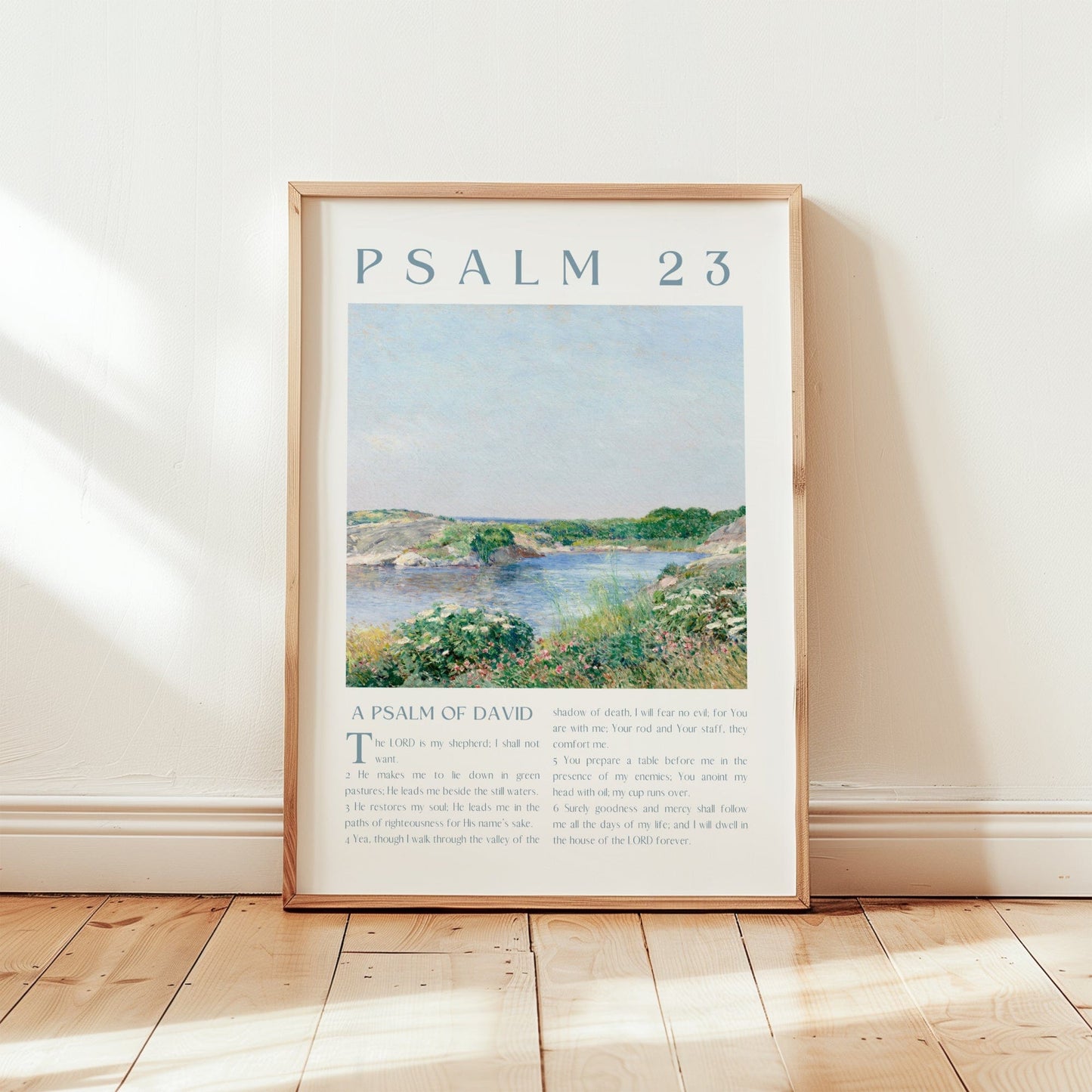 Framed artwork with 'Psalm 23' text and a landscape illustration on a wall.