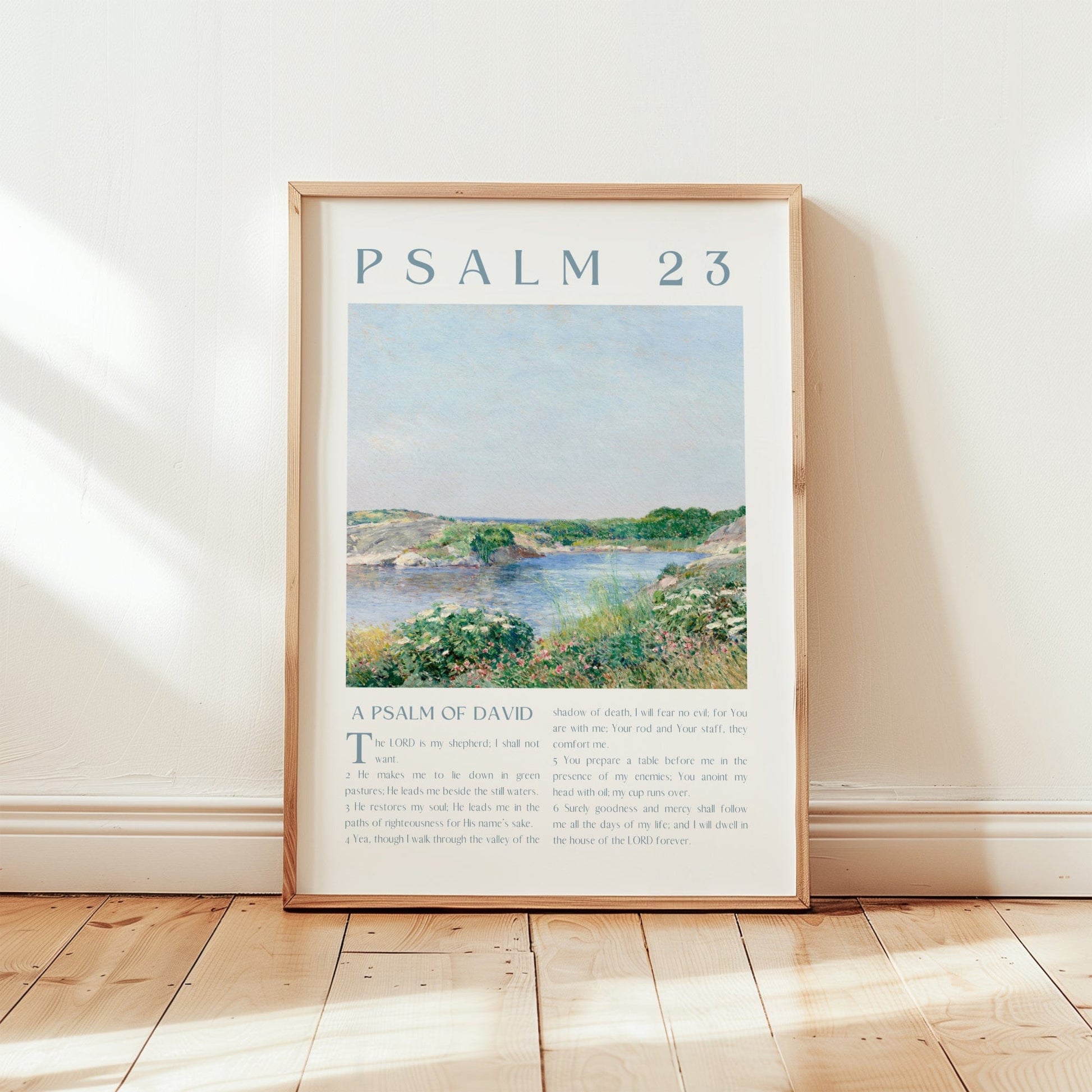 Framed artwork with 'Psalm 23' text and a landscape illustration on a wall.