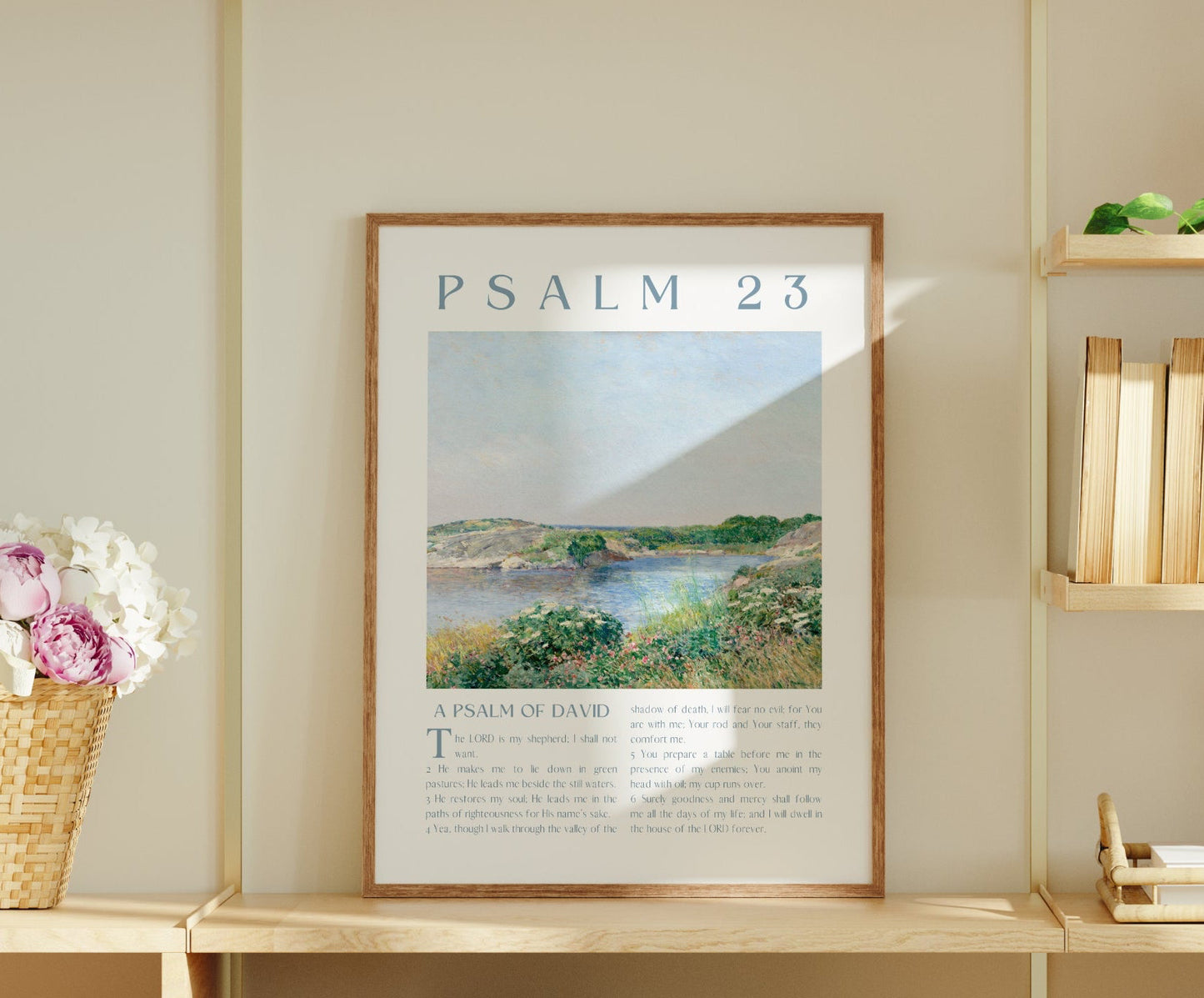 Wooden bookshelf with books, a framed poster, and decorative items against a light wall.