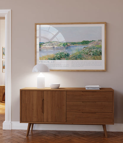Wooden sideboard in a room with a framed landscape print on the wall.