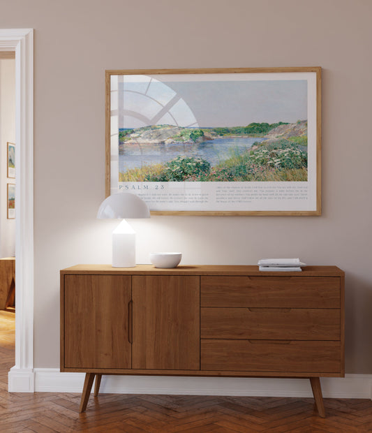 Wooden sideboard in a room with a framed landscape print on the wall.