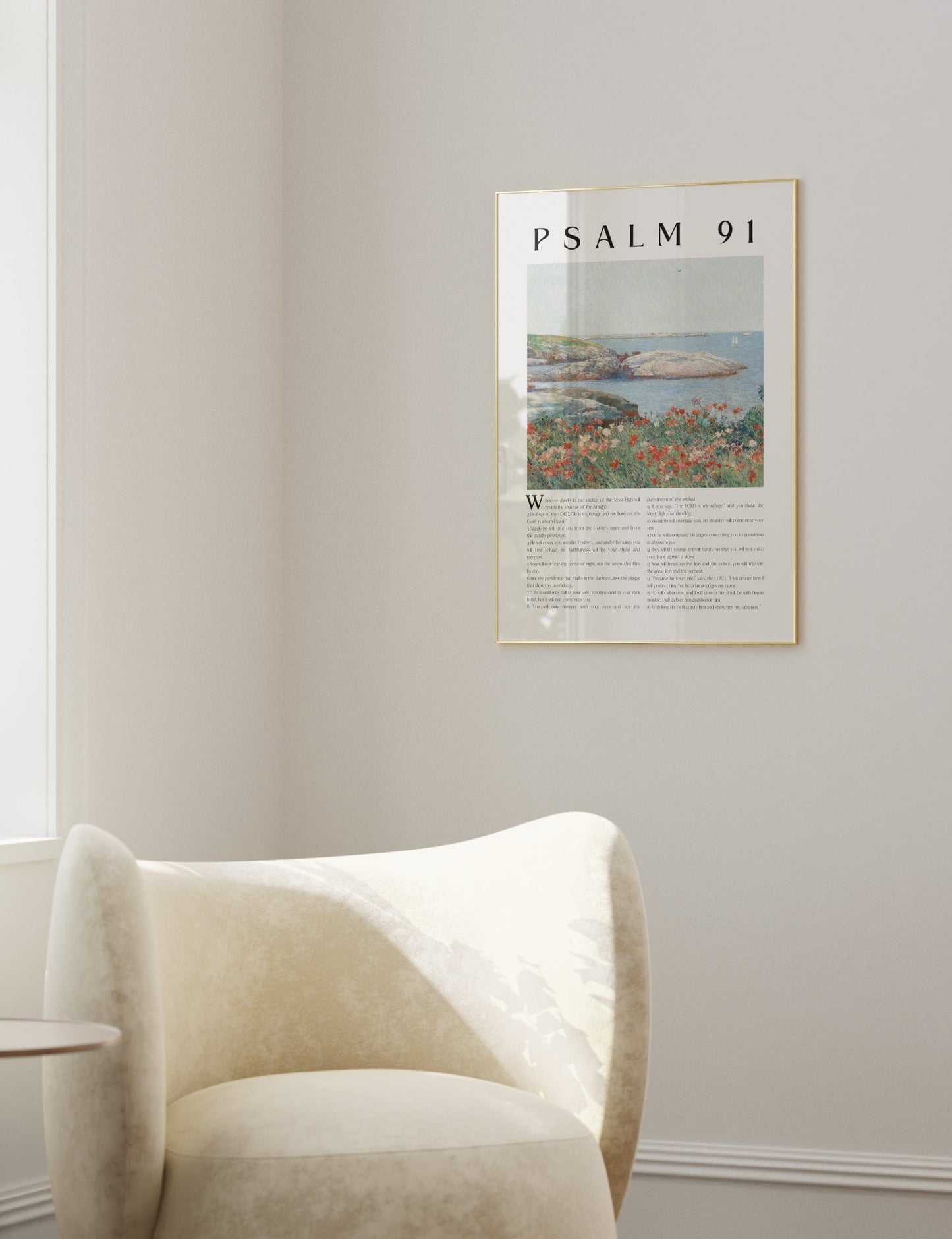 Modern living room with a white armchair, side table, and framed artwork on the wall.
