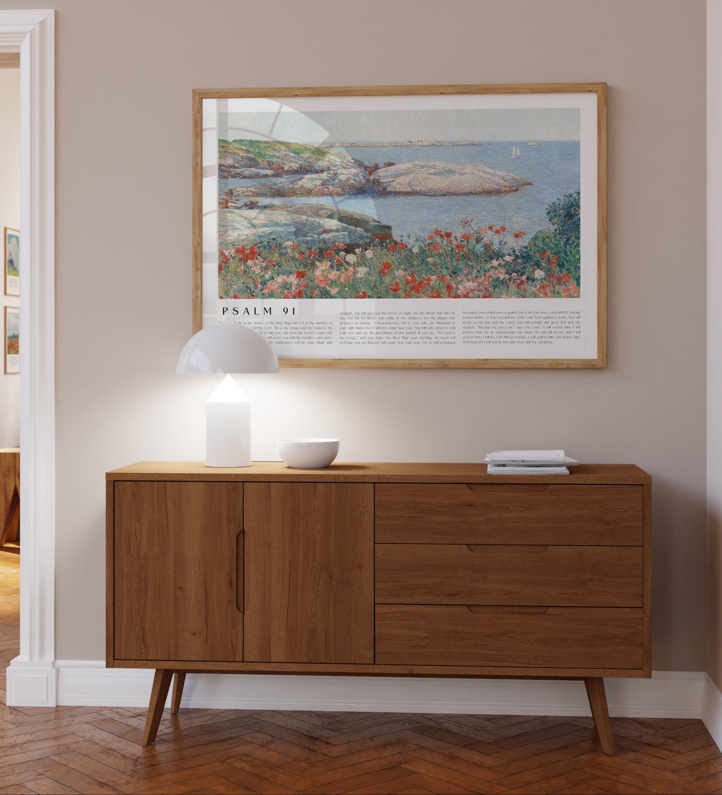 Wooden sideboard against a wall with a framed artwork above it.