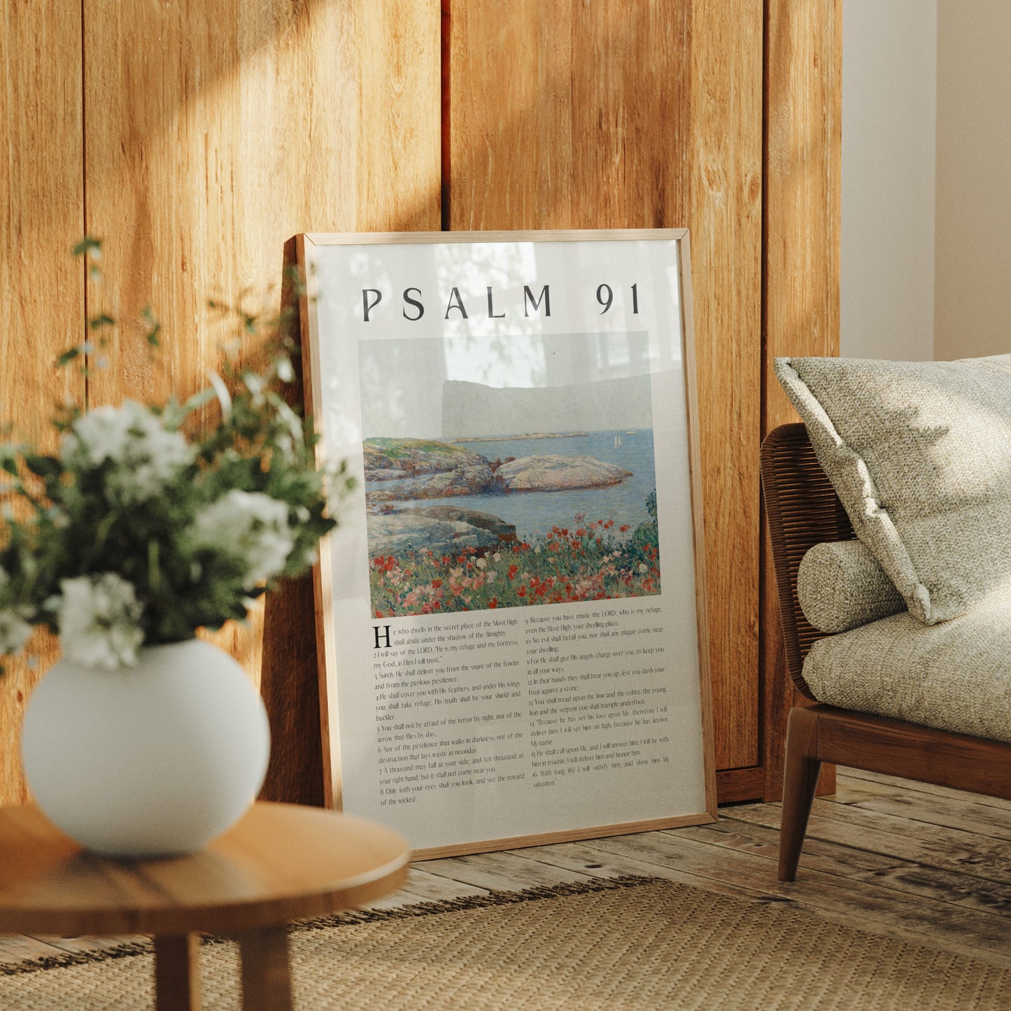 Poster titled 'Psalm 91' in a room with a wooden wall, vase with flowers, and chair.