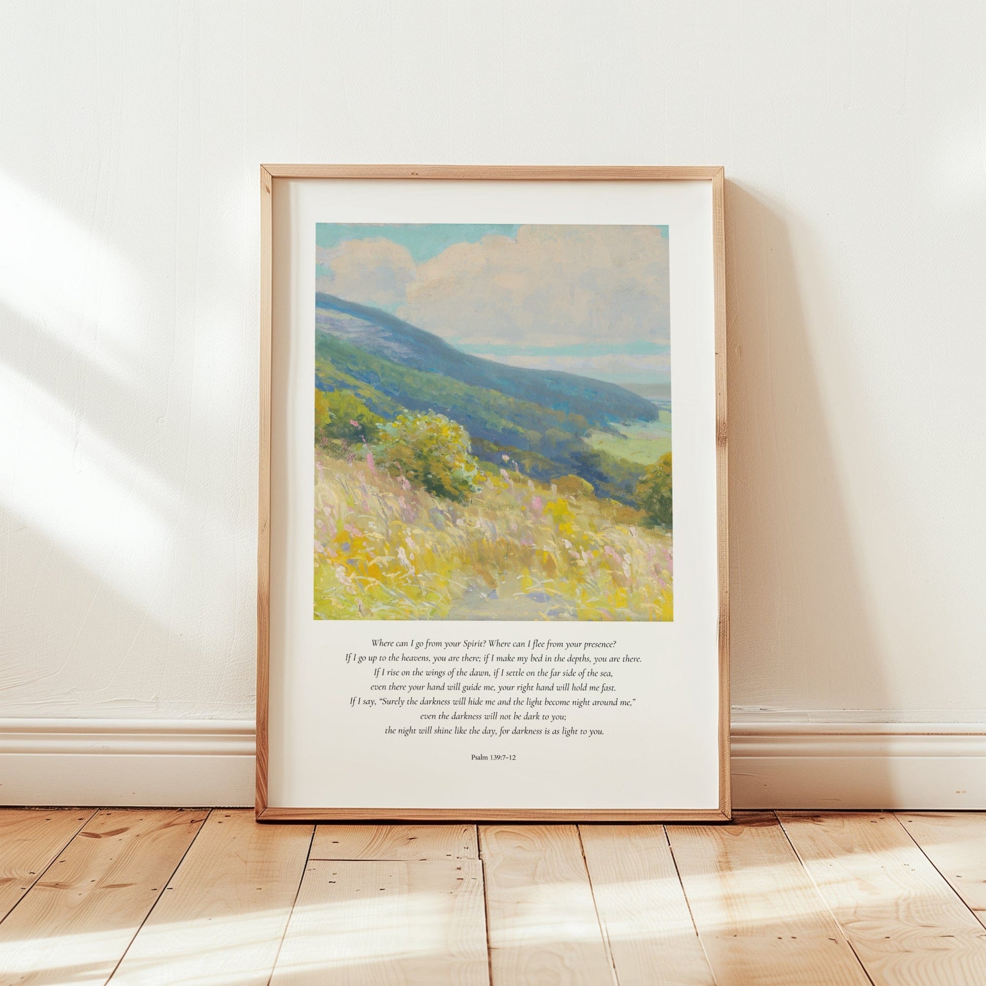 Framed artwork of a landscape with text on a wooden floor and white wall.
