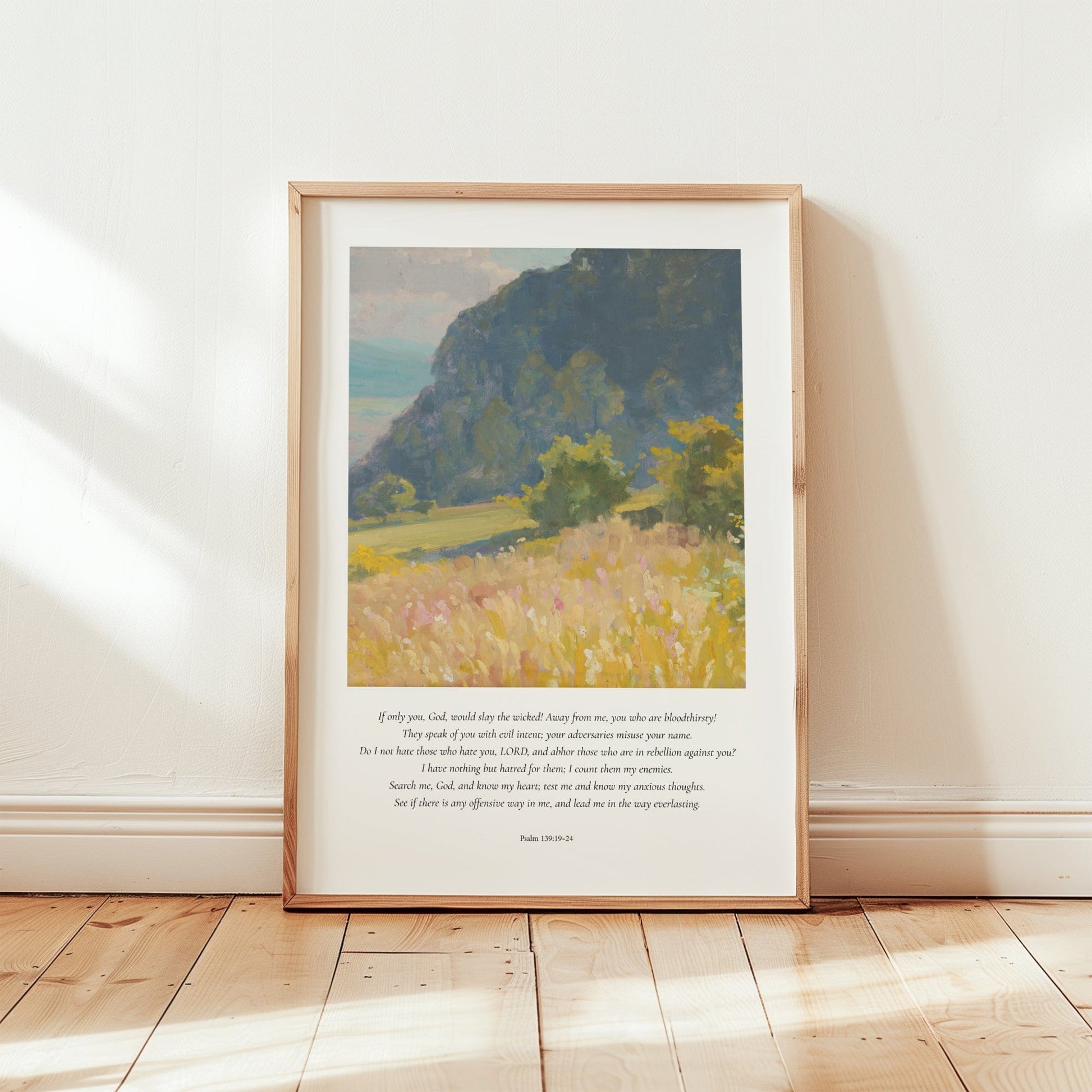 Framed artwork of a landscape with text on a white wall.