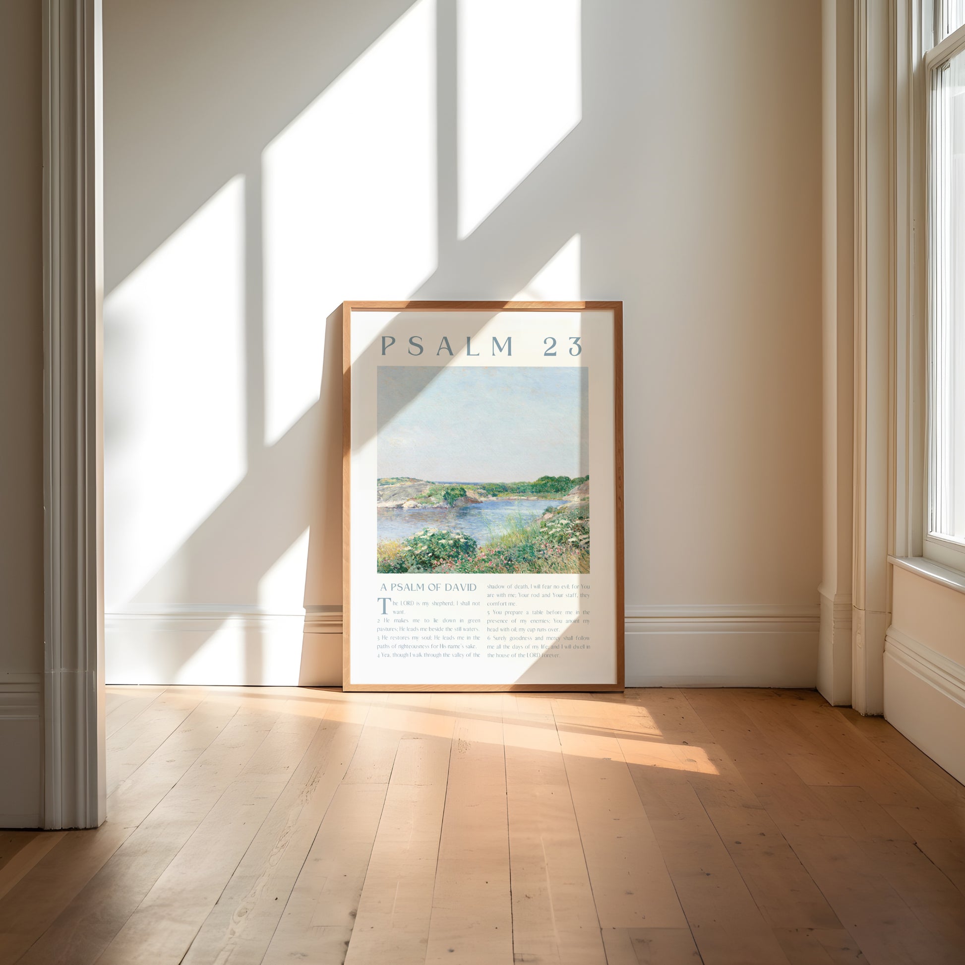 Framed artwork with 'Psalm 23' text in a bright room with large windows.