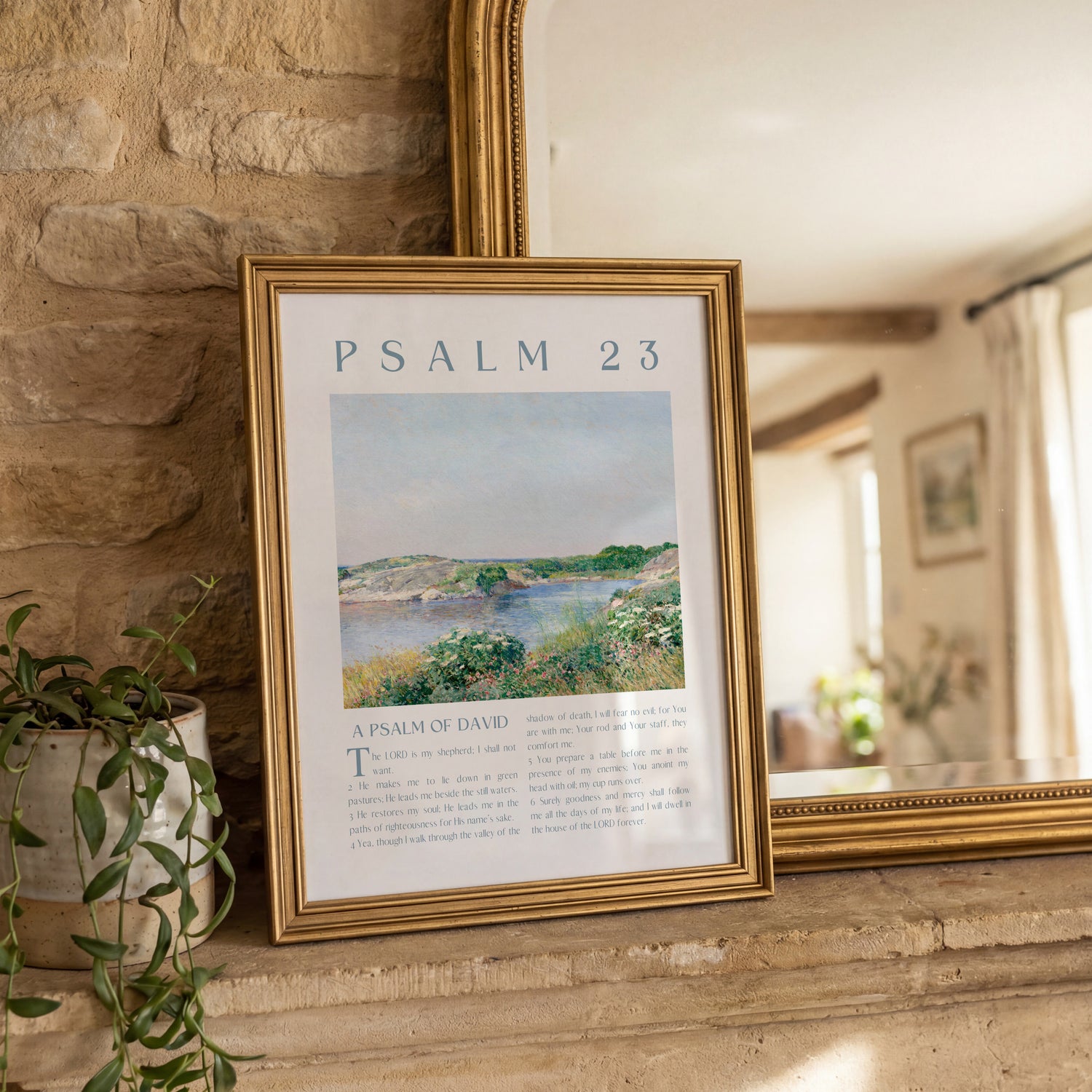 Framed artwork with 'Psalm 23' text and landscape illustration on a stone wall.